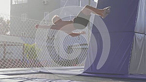 Professional gymnast jumping on the trampoline and doing tricks in air