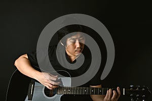 Professional musician playing acoustic guitar in music recording