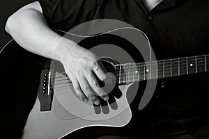 Professional musician playing acoustic guitar in music recording