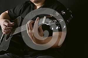 Professional musician playing acoustic guitar in music recording