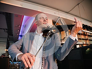 Professional Musician Playing Electric Violin Indoors