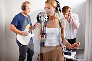 Professional, musician and woman with microphone, headphones and band performance with talent. Recording studio, art and