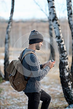 Professional nature photographer outdoor in the winter forest.
