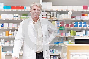 Professional near counter. Portrait of smiling medical professional standing near counter at drugstore.