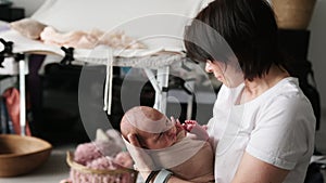 Professional Newborn Photographer With Baby In Photo Studio