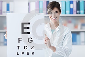 Professional oculist holding an eye chart