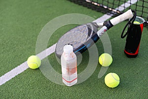 professional paddle tennis racket with natural lighting on court background. Horizontal sport theme poster, greeting