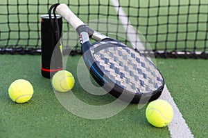 professional paddle tennis racket with natural lighting on court background. Horizontal sport theme poster, greeting