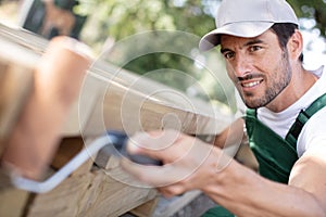 professional painter painting bench in park