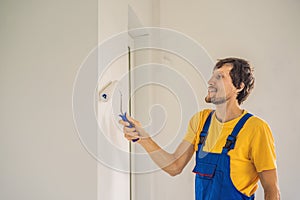 Professional painter worker painting and priming wall with painting roller