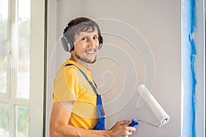 Professional painter worker painting and priming wall with painting roller