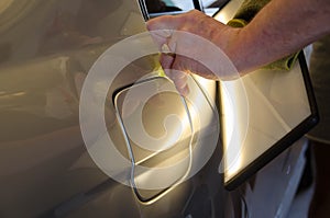 Professional Paintless Dent Repair Technician Is Repairing Dents On Car Body. Hands Of Car Mechanic. Process Of Removing