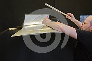 Professional Paintless Dent Repair Technician Is Repairing Dents On Car Body. Man Removing Dent On Car Hood After Hail