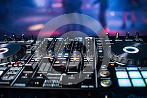 Professional panel of DJ console for mixing music in nightclub at party