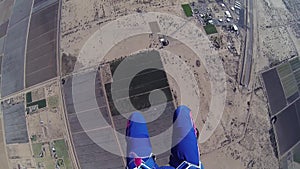 Professional parachute jumper parachuting above arizona. Sands. Horizon.