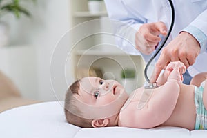 Professional pediatrician examining infant