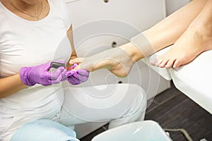 Professional pedicure applying fingernail polish