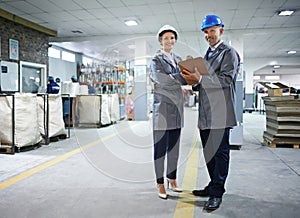 Professional, people and packaging warehouse with clipboard by working together checking checklist for manufacturing