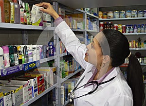 Professional pharmacist checking stock of a local drugstore