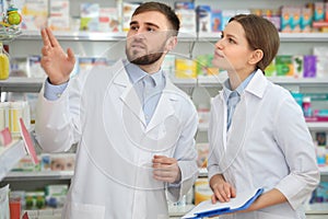 Professional pharmacists working together in drugstore