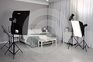 Professional photo studio equipment prepared for shooting bedroom interior