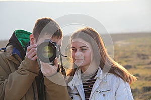 Professional photograper teaching young girl about camera and taking pictures photo