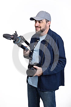 Professional photographer with camera and tripod on white background