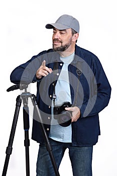 Professional photographer with camera and tripod on white background