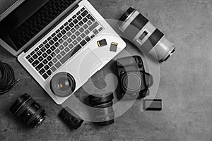 Professional photographer equipment and laptop on gray background