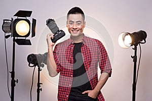 Professional photographer. Portrait of confident young man in sh