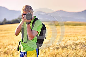 Professional photographer standing in rye field