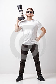 Professional photographer in t-shirt use digital camera with lon