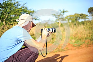 Professional photographer taking photo on savannah