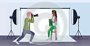 Professional photographer using camera man shooting beautiful sexy african american woman model posing modern photo