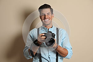 Professional photographer working on beige background in studio