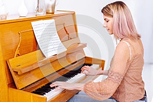 Professional pianist arranging music on piano