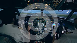 Professional pilot is giving instructions to an amateur while taking off in a flight simulator