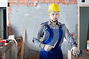 Professional plasterer is ready to plaster the walls