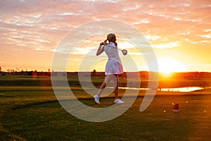 Professional Player Woman Play Golf With Sunset Background .