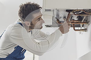 Professional plumber checking a boiler