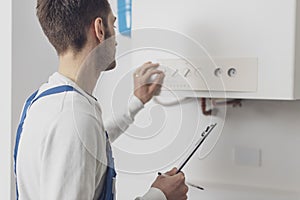 Professional plumber checking a boiler control panel