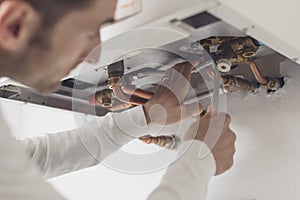 Professional plumber checking a boiler