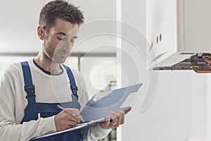 Professional plumber doing a boiler check