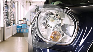 After professional polishing, ceramics and car washes show headlights on new cars. Concept of: Auto Service, Different Colors, Car