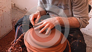 Professional potter making bowl