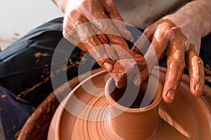 Professional potter making bowl