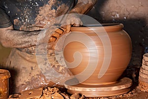 Professional potter making bowl in pottery workshop, studio