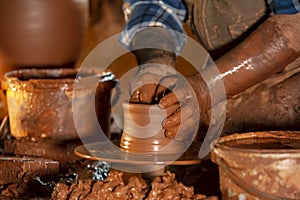 Professional potter making bowl in pottery workshop, studio