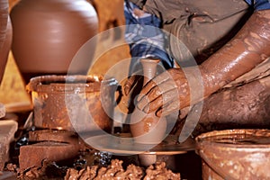 Professional potter making bowl in pottery workshop, studio