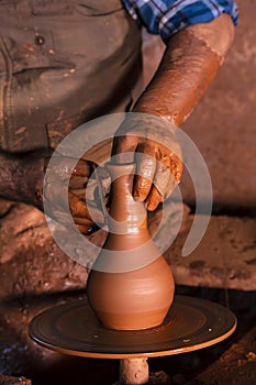 Professional potter making bowl in pottery workshop, studio